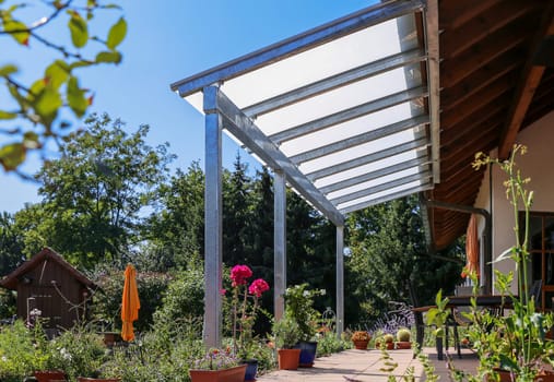 Glass patio cover with a view of the garden.
