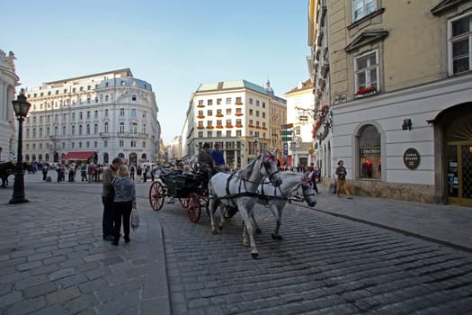 Traditional old-fashioned fiacres at Michaelerplatz near Hofburg of Vienna, Austria