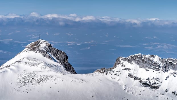 View from Kasprowy Wierch on near by mountain peak at winter. Tatra Mountains range with snow capped mountain peaks, Poland