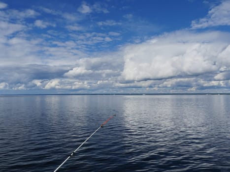 sea fishing, seascape cumulus clouds reflected in sea water
