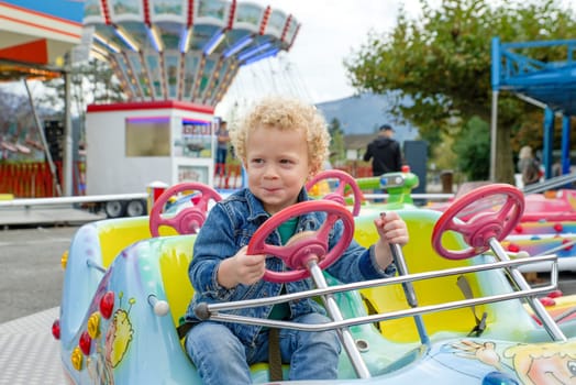 a portrait of little boy in a merry-go-round