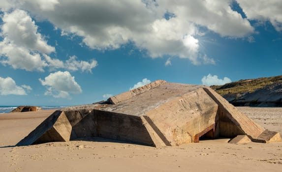 the ruins of german bunker in the beach of Normandy, France