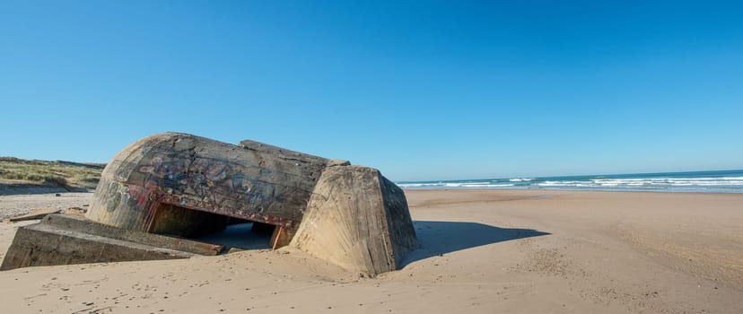 the ruins of german bunker in the beach of Normandy, France
