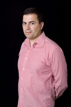 young casual man portrait on a black background