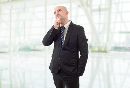 young business man thinking, at the office