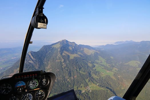 A flight with the helicopter over the Allgaeu with the mountain Gruenten