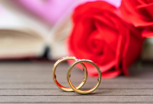 Close up wedding ring and red rose . Love concept