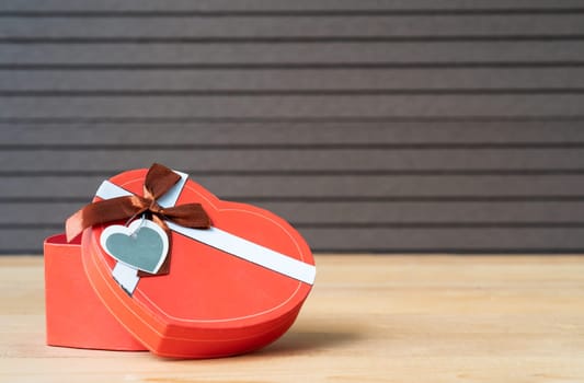 Close up heart-shaped box on wood background,Valentines Day concept with red heart-shaped box