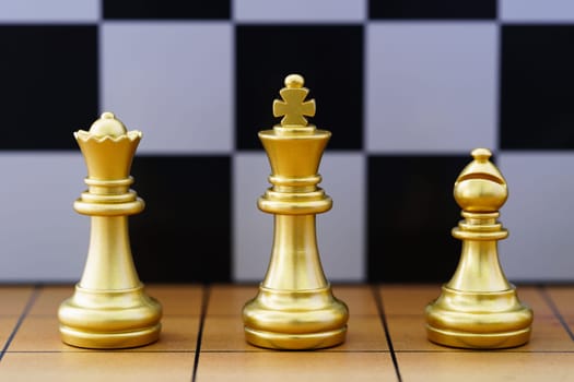 Gold king chess piece and various chess pieces stand on wood chessboard ,Concept of leadership game of strategy