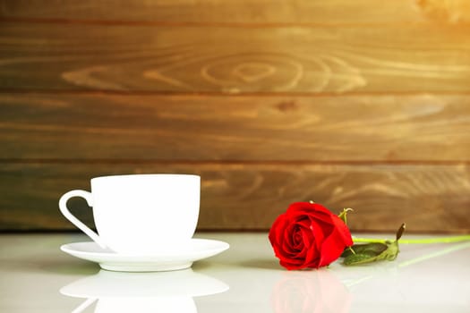 Red roses and coffee cup on table with copy space, Valentine's day concept with red roses