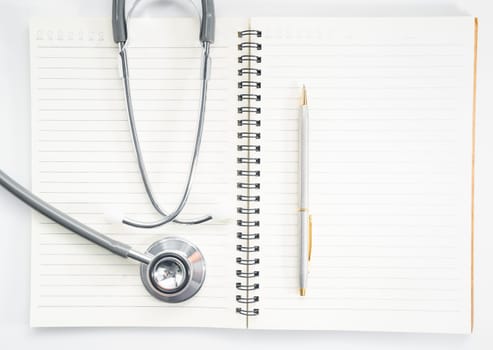 Close up stethoscope on blank notepad as medical concept