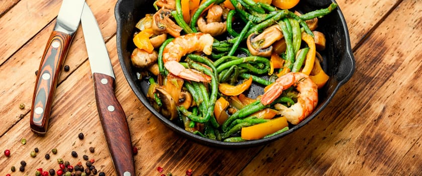 Salad with atlantic shrimps and asparagus beans.Stew with seafood and vegetables.