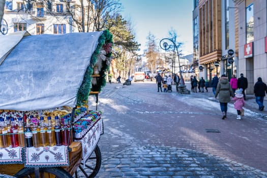 Zakopane, Poland, March 2019 Traditional carriage with homemade preserves and oscypek cheese on Krupowki promenade, main shopping area.
