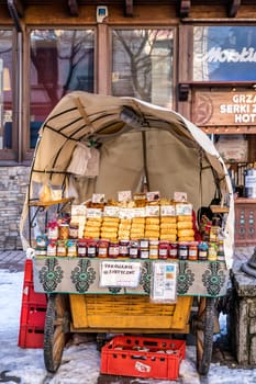 Zakopane, Poland, March 2019 Traditional carriage with homemade preserves and oscypek cheese on Krupowki promenade, main shopping area.