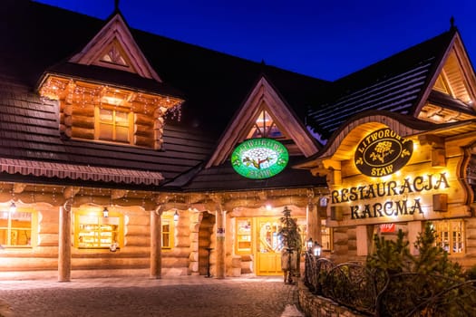 Bialka Tatrzanska, Poland, March 2019 Traditional Polish wooden restaurant at night time. Popular winter sports village in Tatra Mountains