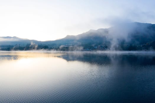 Magic foggy sunrise over Colibita lake at autumn, Romania.