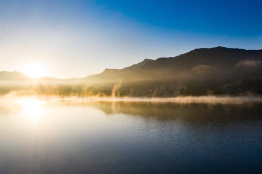 Magic foggy sunrise over Colibita lake at autumn, Romania.
