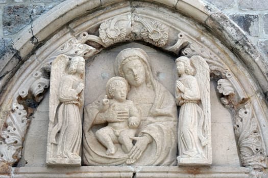 Statue of the Virgin Mary with baby Jesus on the portal of the church of St. Mary of Mercy in Dubrovnik, Croatia