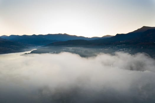 Magic foggy sunrise over Colibita lake at autumn, Romania.