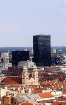 Basilica of the Sacred Heart of Jesus and the new metal and black glass office buildings in the center of the city in the background in Zagreb, Croatia