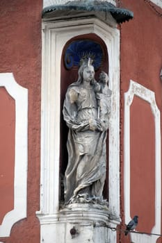 Virgin Mary with baby Jesus, statue on the house facade in Ptuj, town on the Drava River banks, Lower Styria Region, Slovenia