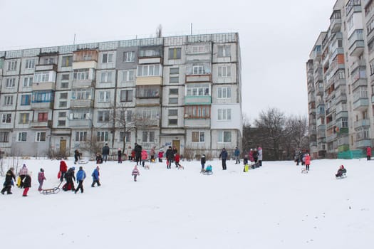 many town and joy children are sleding from the hill