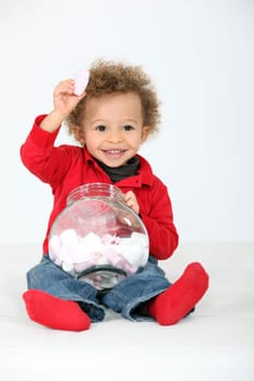 Little boy eating sweets
