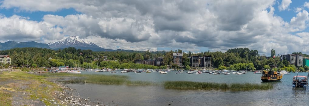 Boats on the shore of Lake Villarrica with the volcano of the same name, Pucon, Chile