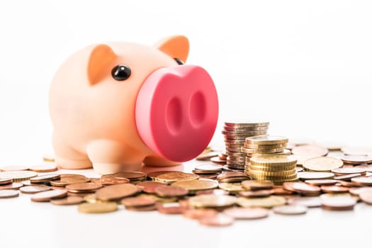 Piggy bank moneybox with euro coins on white background.