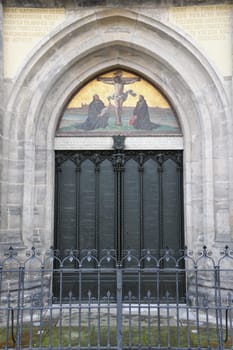 Historical 95 disputation theses of Martin Luther at the thesis door of the castle church in Wittenberg