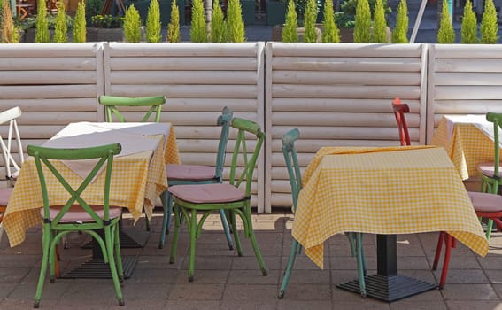 Cafe tables and chairs at city street outdoor