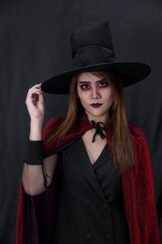 Portrait of asian young adult teenage woman wear Halloween costume cloth for Halloween party carnival. Halloween celebrate and international holiday concept.