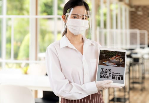 Asian Young adult in car holding disposable bag for take out food from drive thru service restaurant. Drive thru is new normal and popular service after coronavirus covid-19 pandemic.