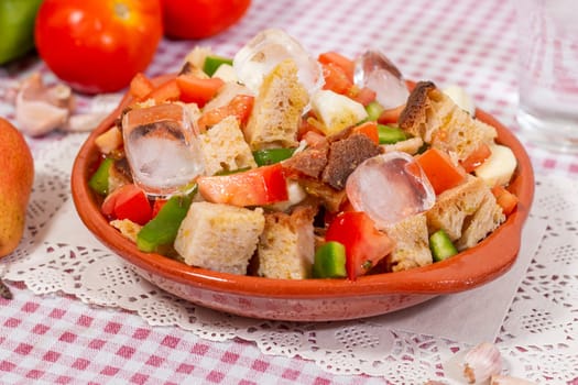 Typical Portuguese Gaspacho meal with bread, tomato, green bell pepper and cucumber, seasoned with olive oil and garlic and cold water.