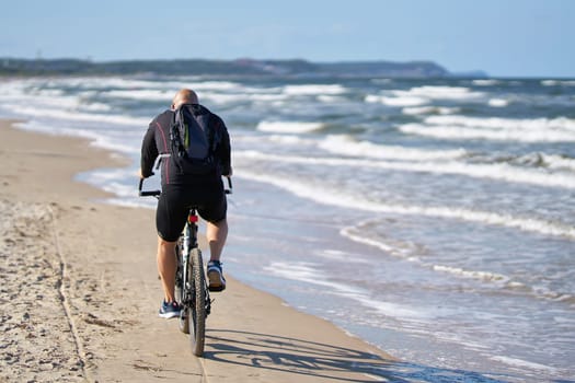 Cyclists on the deserted beach of Swinoujscie on the Polish Baltic Sea coast