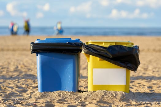 Waste bins on the beach of Swinoujscie in Poland for the cleanliness of the beach as a fight against mass tourism