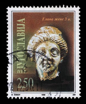 Stamp issued in Yugoslavia shows Woman`s head from 3rd century, circa 1996.