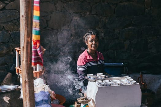 Dahat, Ethiopia - April 23, 2019: Ethiopian traditional Coffee maker, local women preparing bunna cafe Dahat, Ethiopia, Africa