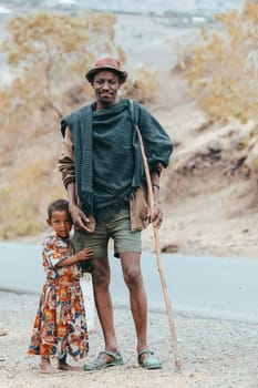 AMHARA REGION, ETHIOPIA, APRIL 22.2019, Ethiopian herdsman man with daughter near Gondar city. Amhara region, Ethiopia, April 22. 2019