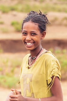 AMHARA REGION, ETHIOPIA, APRIL 22.2019, Ethiopian shepherdess girl with thorn clothes near Gondar city. Amhara region, Ethiopia, April 22. 2019