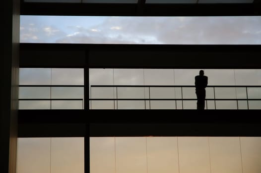worker inside the building silhouette at sunset