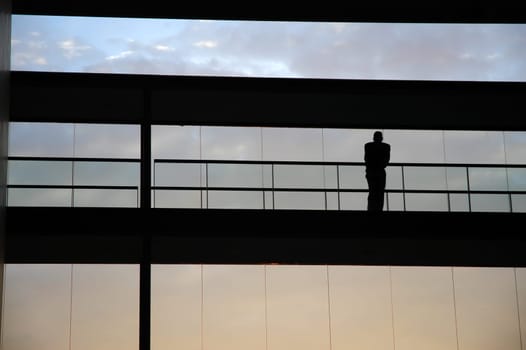 worker inside the building silhouette at sunset
