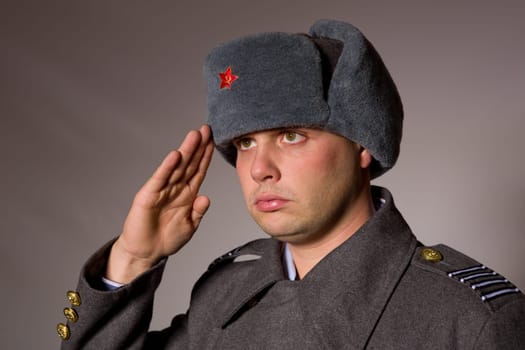 young man dressed as russian military, studio picture