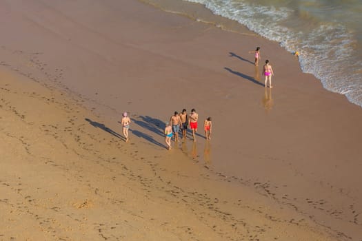 ALBUFEIRA, PORTUGAL - AUGUST 22, 2017: People at the famous beach of Praia da Felesia in Albufeira. This beach is a part of famous tourist region of Algarve.