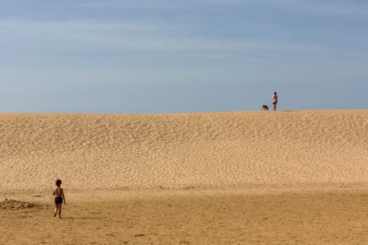 PRAIA DA BORDEIRA, PORTUGAL - AUGUST 20, 2017: People at the dunes of the famous beach of Praia da Bordeira. This beach is a part of famous tourist region of Algarve.
