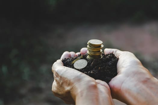 Saving money concept with hand holding money coin stack. financial and accounting concept.