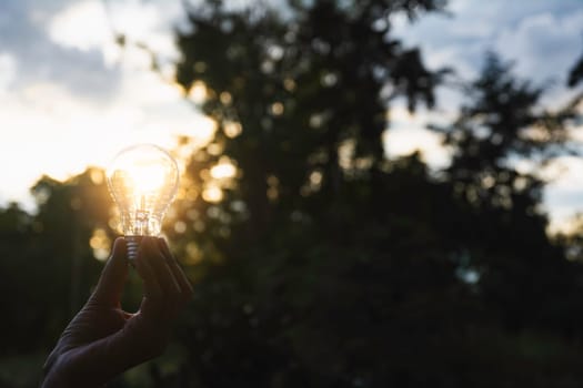 Innovation and energy concept of hand hold a light bulb and copy space for insert text.
