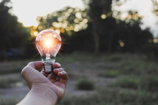 Innovation and energy concept of hand hold a light bulb and copy space for insert text.