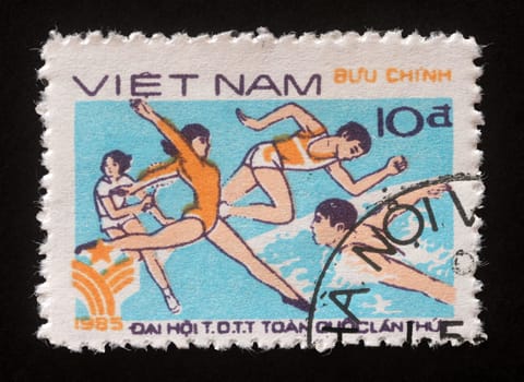 Stamp printed in Vietnam shows Gymnastics, running and swimming, 1st national sports festival, circa 1985.