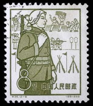 Stamp issued in the China shows Militia, the 1st Anniversary of People's Communes, circa 1959.